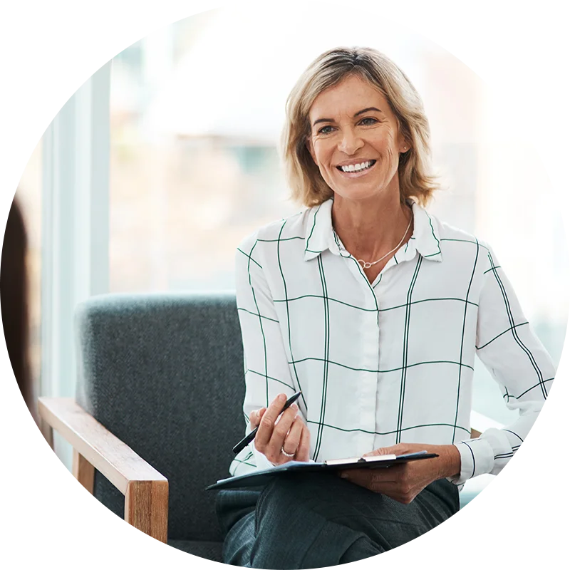 A therapist takes notes and smiles during a session with a new client in the addiction treatment program at Jasper Grove Recovery.