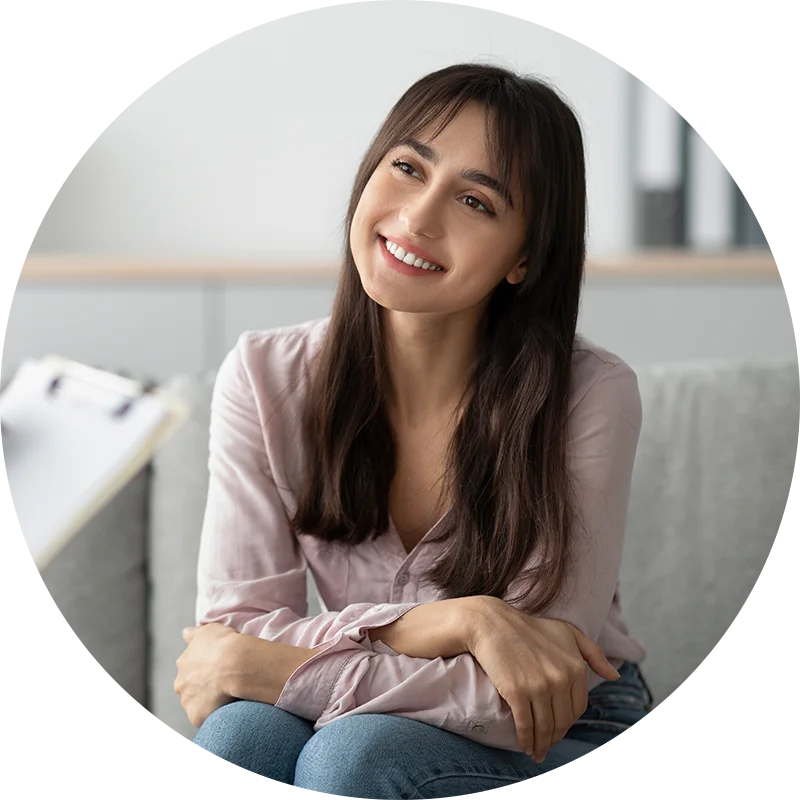 A young woman sits and smiles at her therapist while participating in therapy for co-occurring disorders at Jasper Grove Recovery.