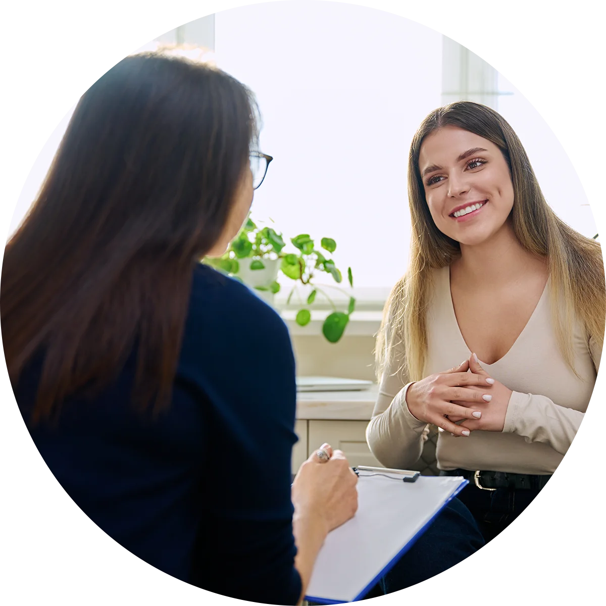 A young woman smiles at her therapist while participating in a therapy program at Jasper Grove Recovery.