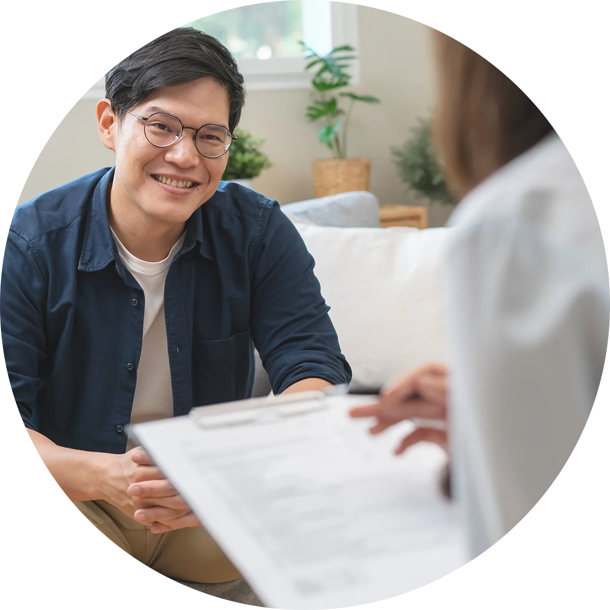 A young man smiles at his therapist while participating in a therapy program at Jasper Grove Recovery.