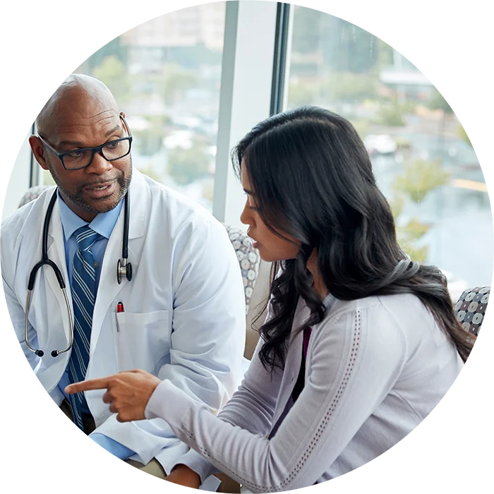 Patient explaining something to their doctor