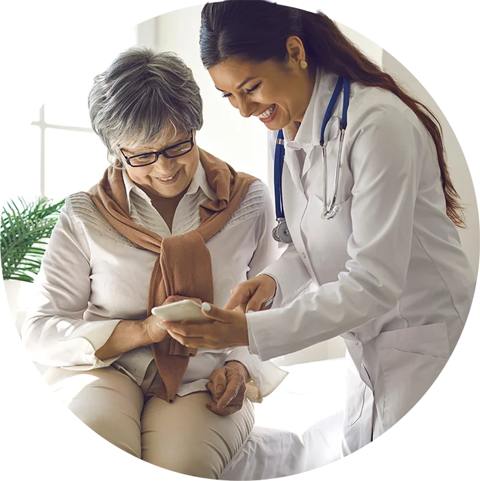 Doctor showing a patient her phone